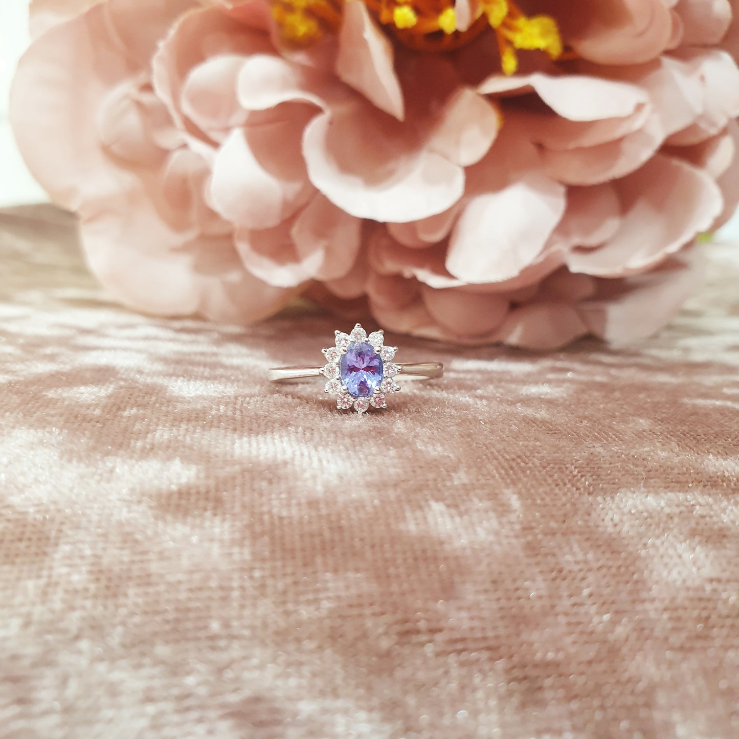 18ct white gold tanzanite diamond engagement ring pink background